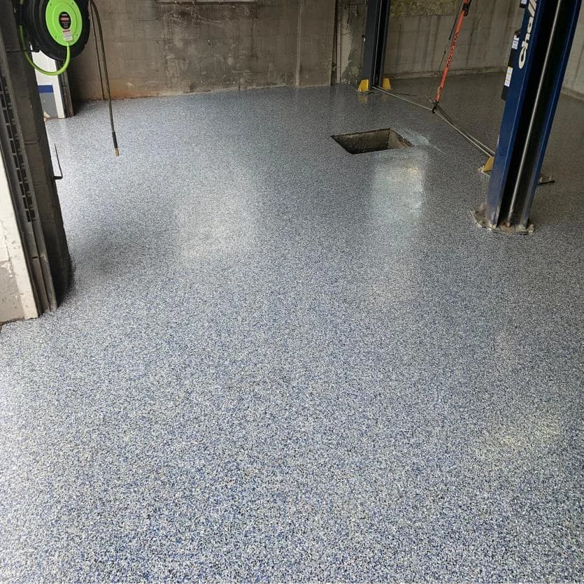 Auto shop service bay with a gray flake concrete floor coating