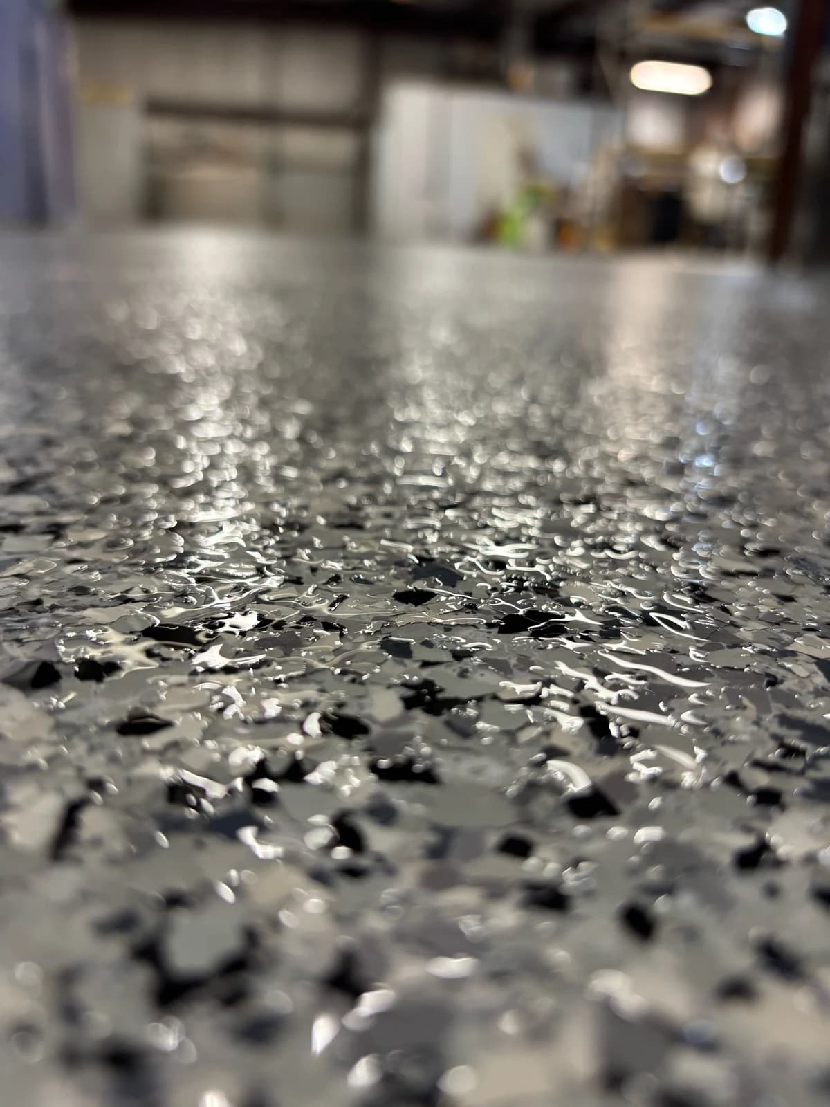 Close-up of a black and white decorative flake floor coating