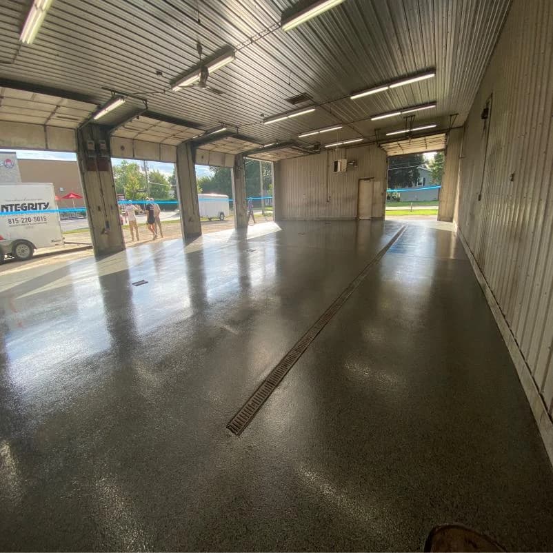 Commercial bay with a polished concrete coating and an Integrity service vehicle outside