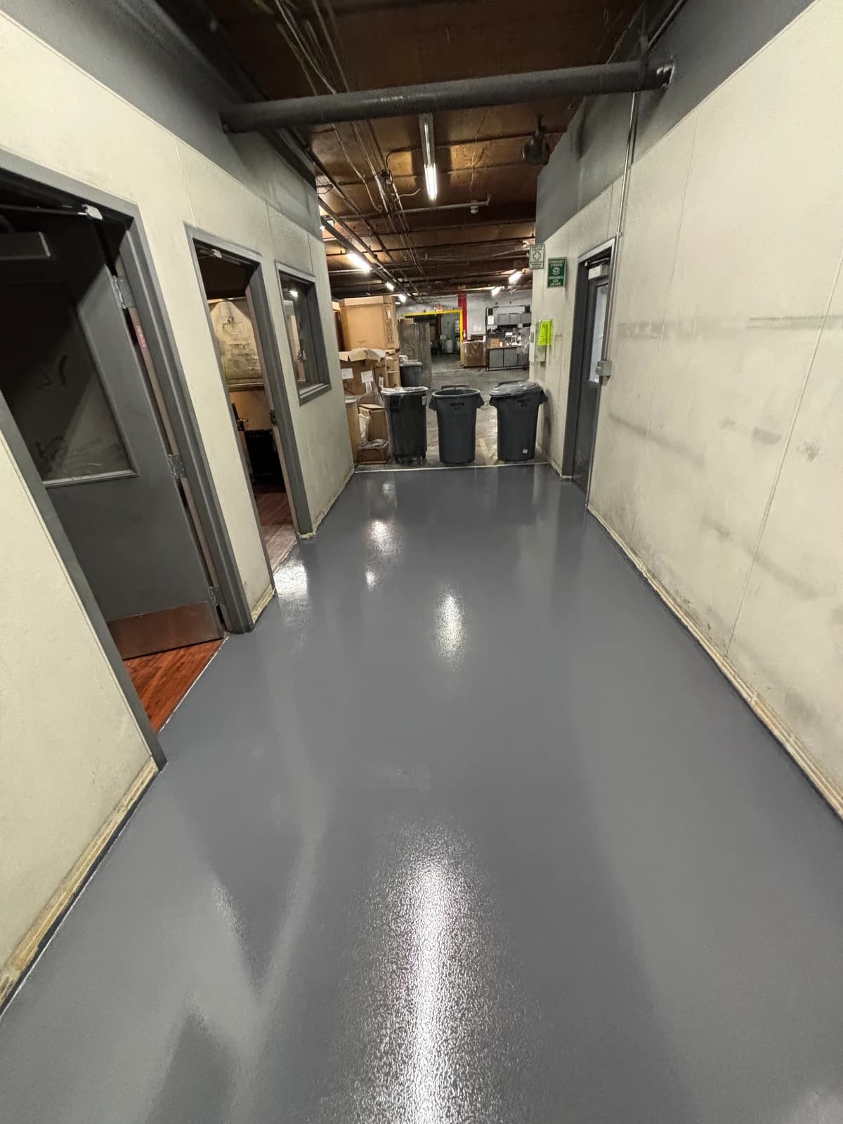Commercial corridor with a high gloss gray epoxy floor coating