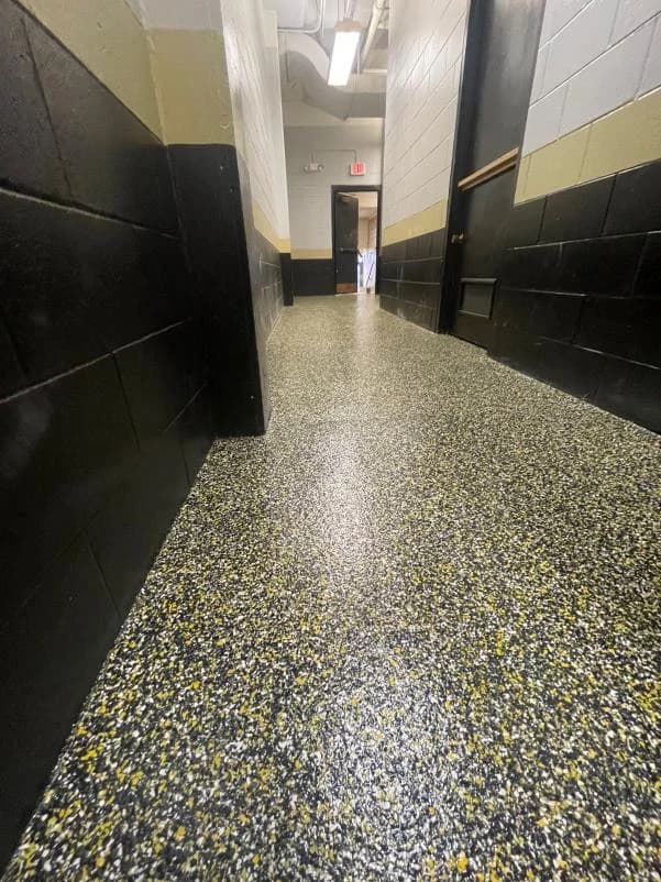 Commercial corridor with a yellow and green flake floor coating