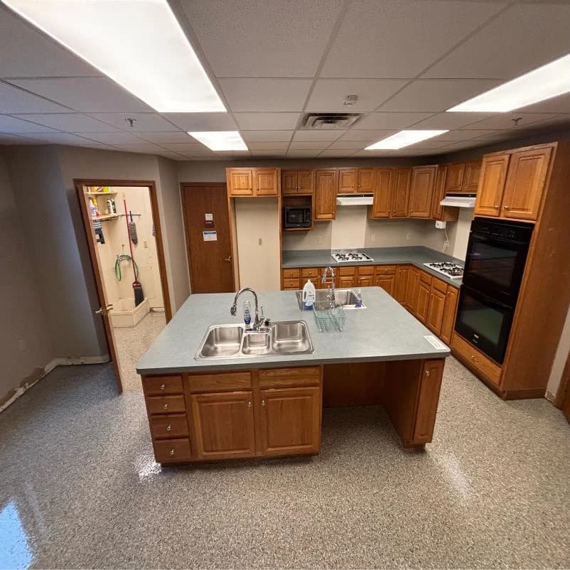 Commercial kitchen with an island and an easy-clean flake floor coating