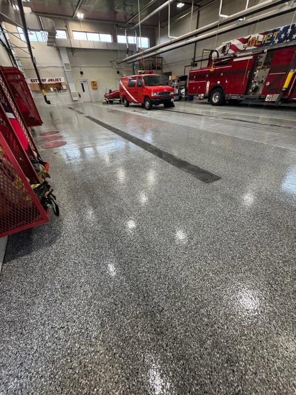 Fire station apparatus bay with a polished gray flake floor coating