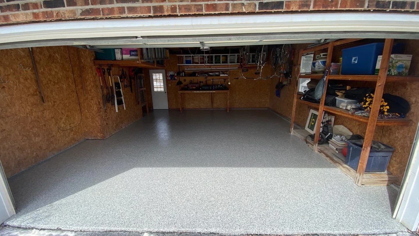 Garage with storage shelving on a gray flake floor coating