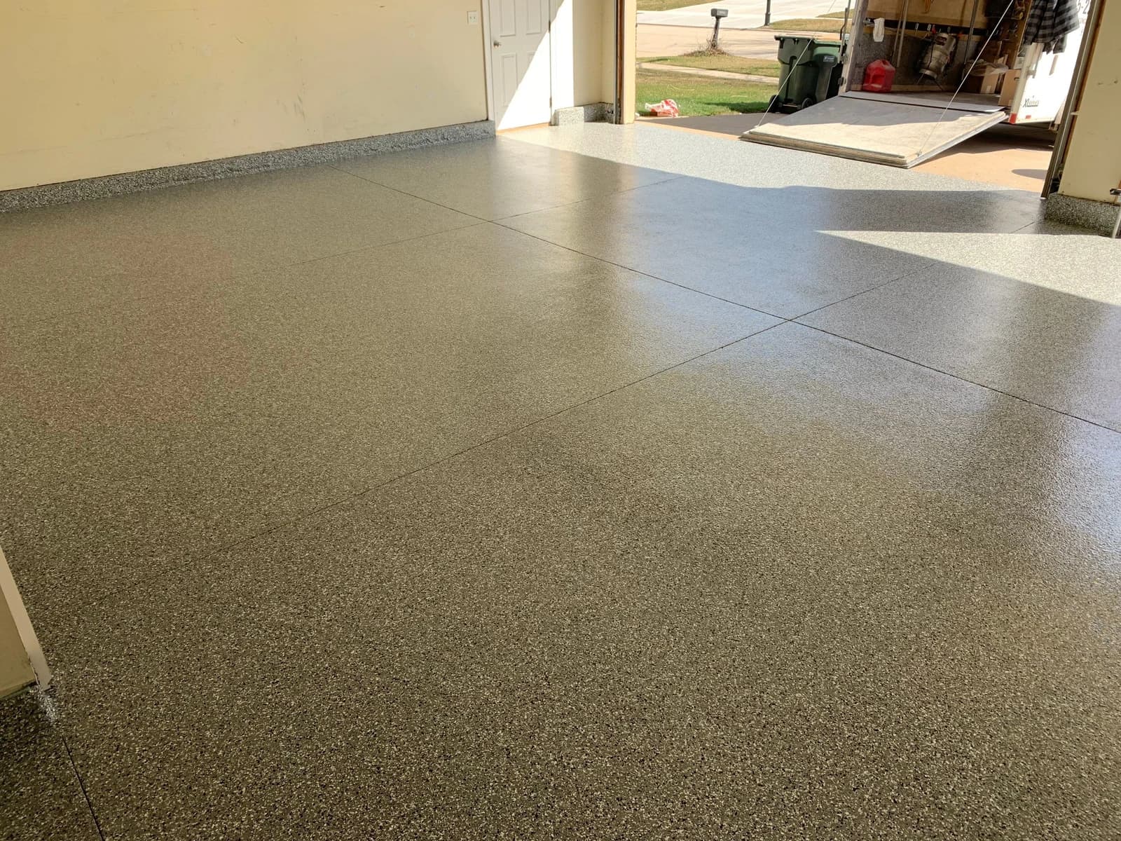 Garage floor finished with a tan and gray decorative flake coating