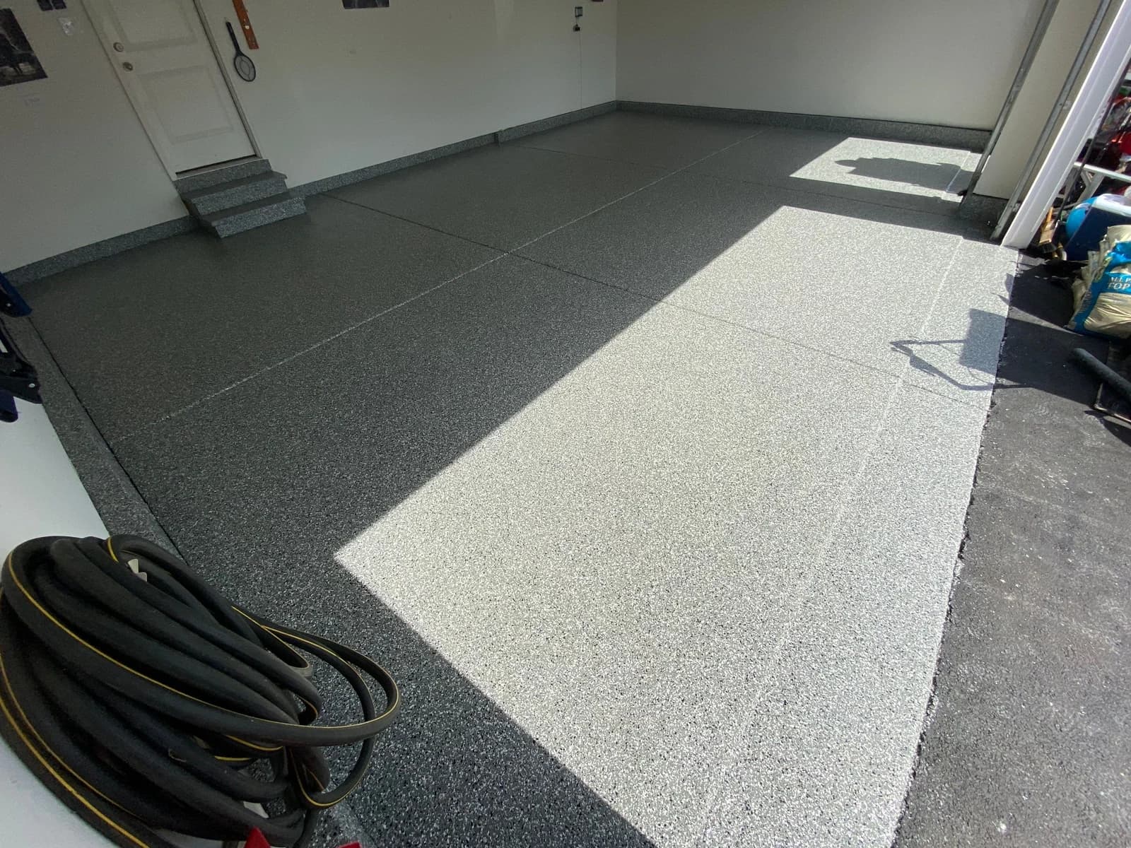 Garage floor coating with a coated step and clean edge detail