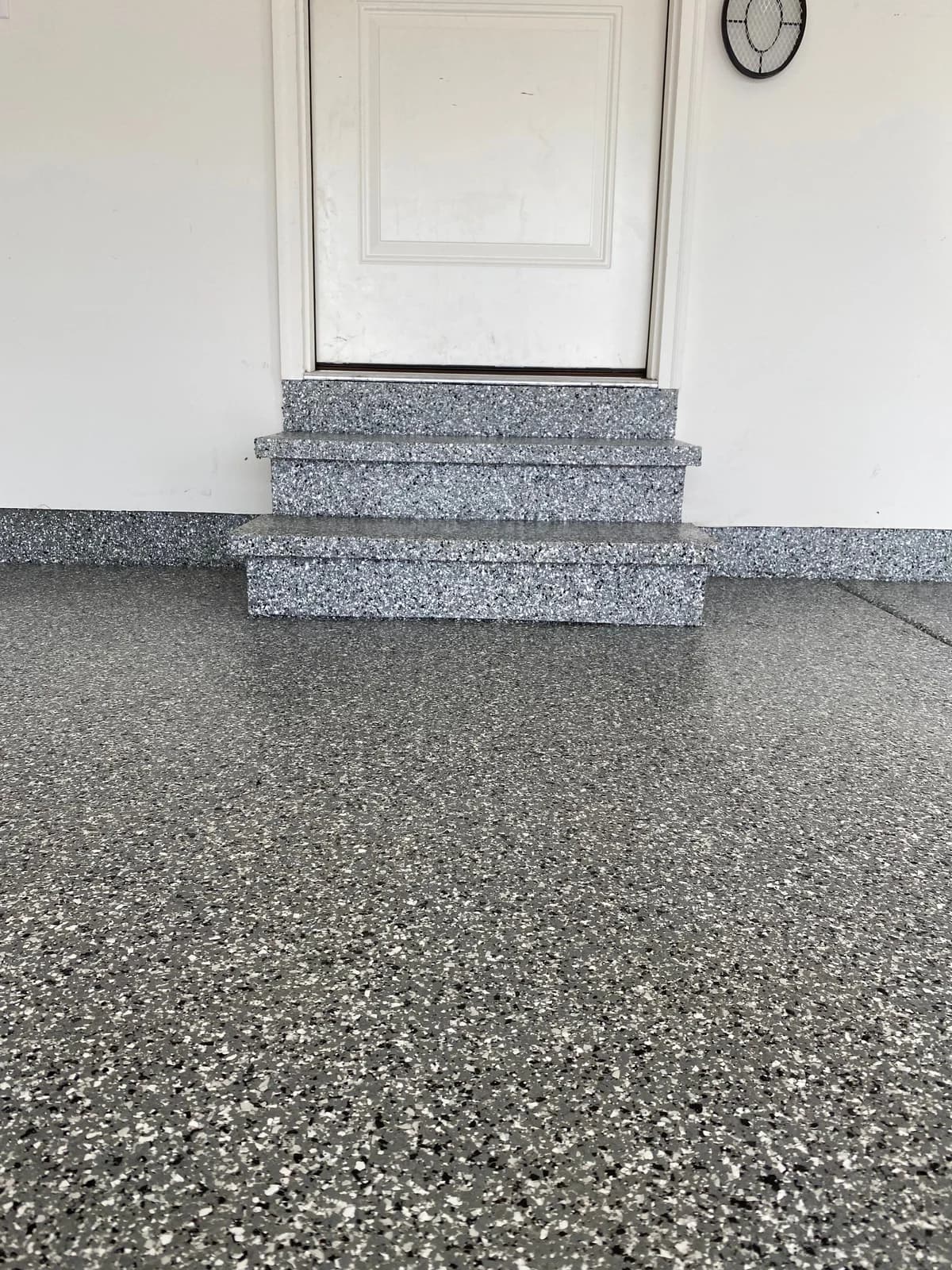 Coated garage steps and floor finished in a matching gray flake blend