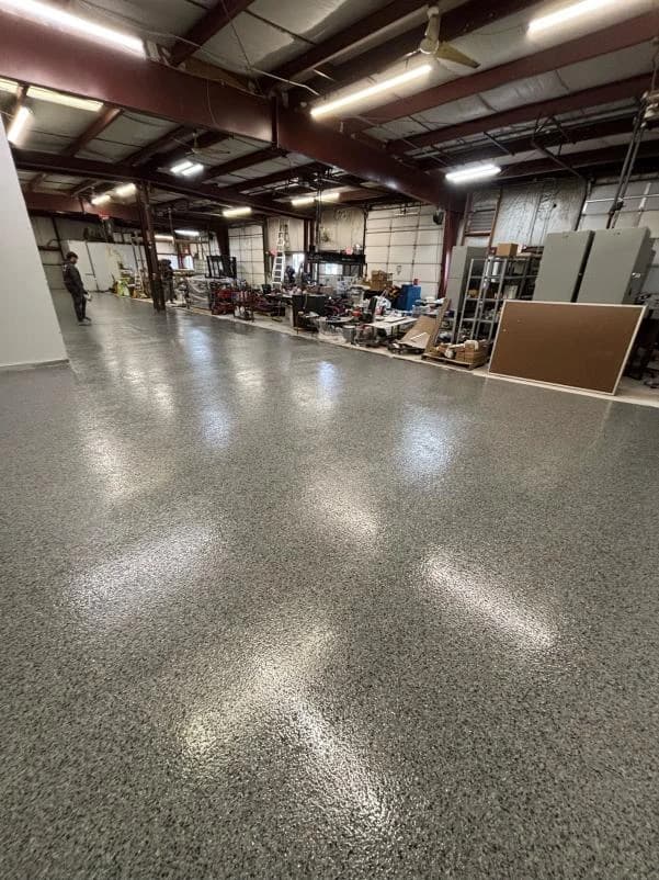 Wide industrial shop floor with a seamless gray flake coating