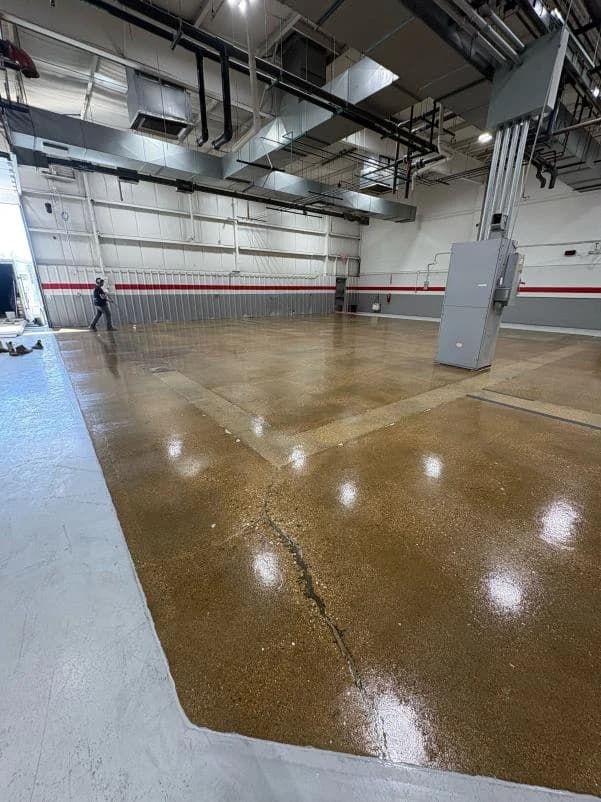 Large industrial warehouse bay with a polished tan concrete coating