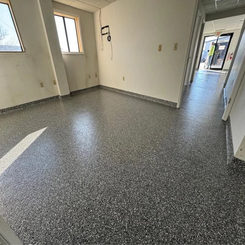 Interior room finished with a gray flake concrete floor coating