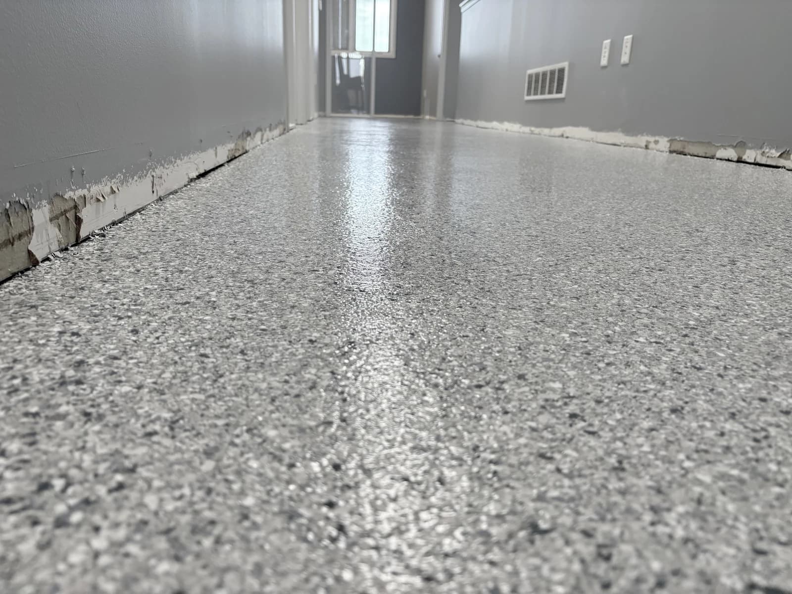 Bright interior room with a gray and white flake floor coating