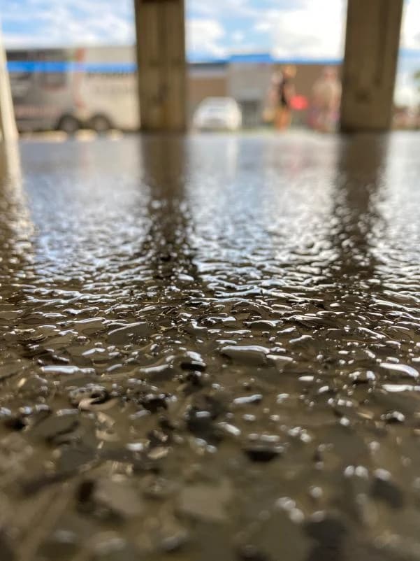 Close-up of the Nightfall flake blend on a coated concrete surface