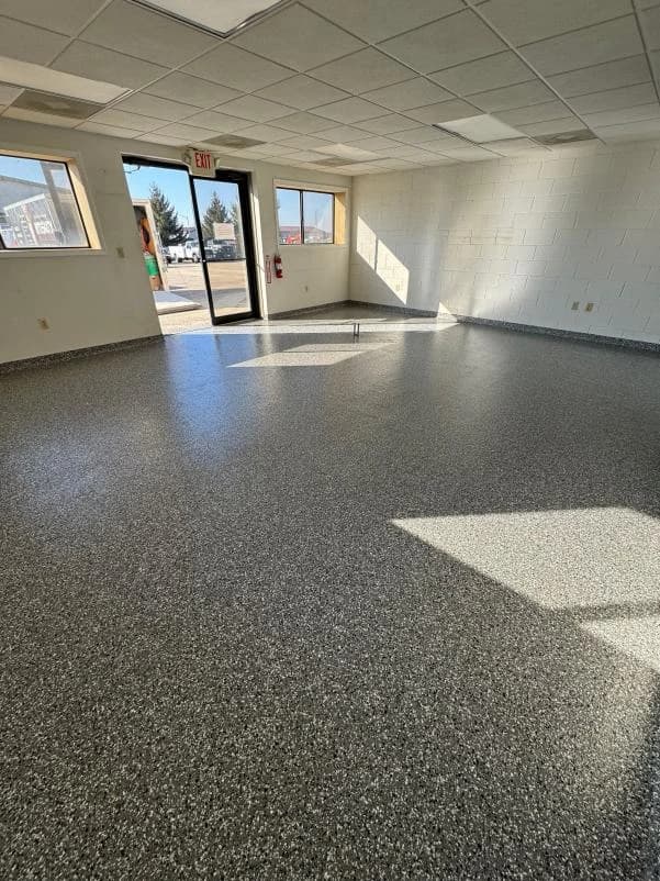 Office space with windows and a gray flake floor coating