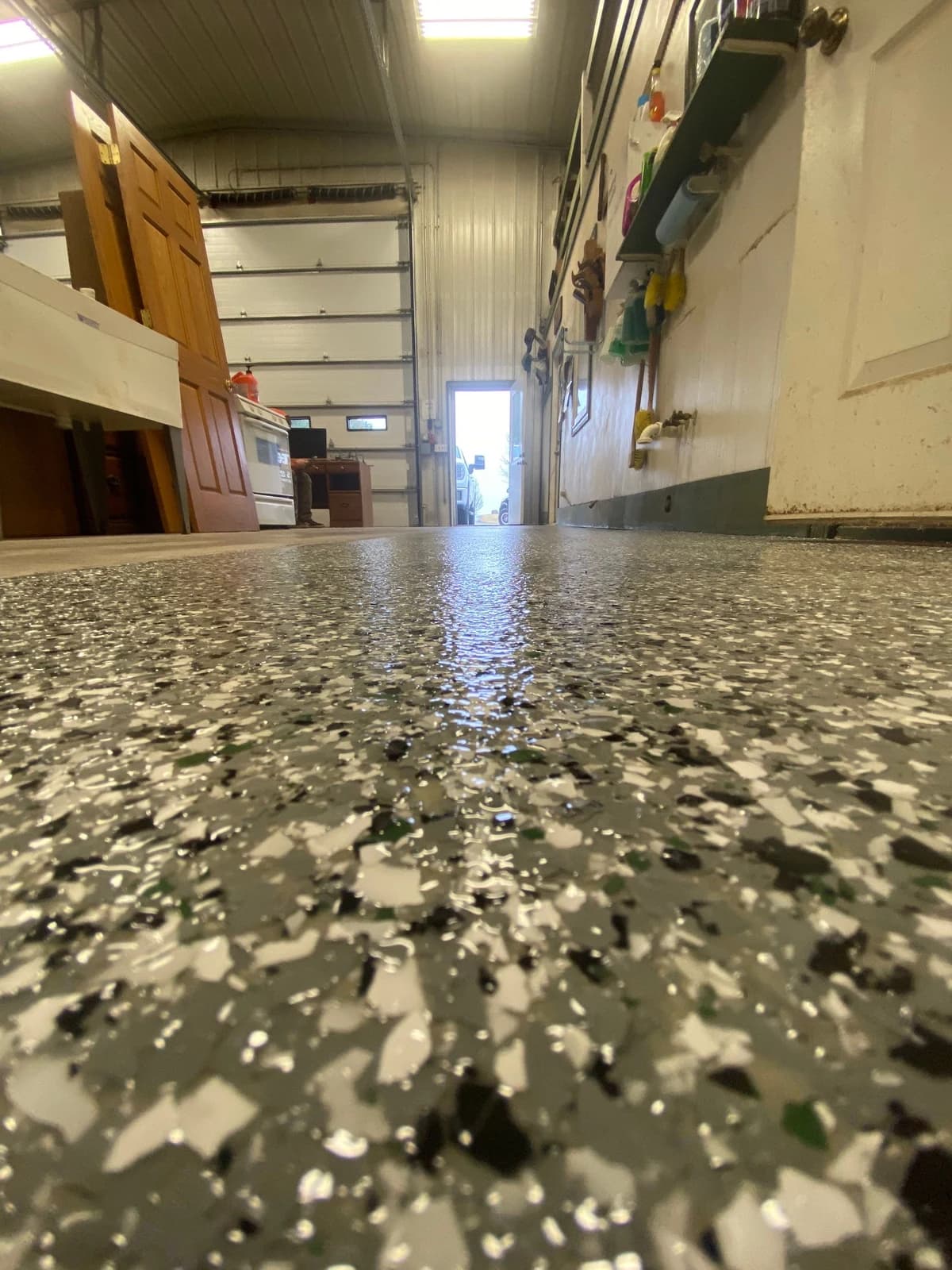 Close-up of a white and black flake floor coating inside a pole barn