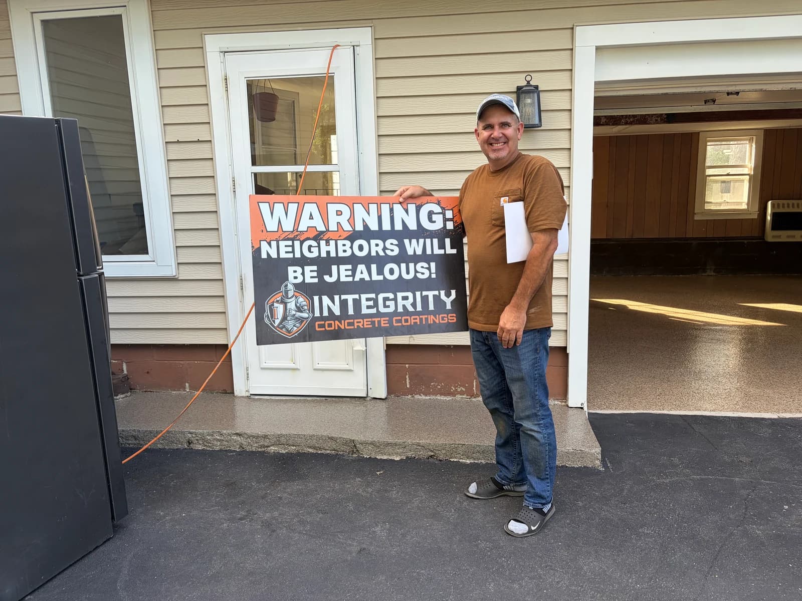 Customer with a Neighbors Will Be Jealous sign beside a coated porch and side entry