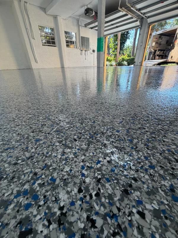 Sunroom floor finished with a blue and white decorative flake coating