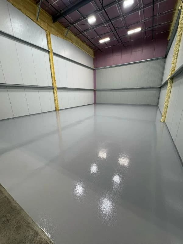 Clean white warehouse room with a glossy epoxy floor coating