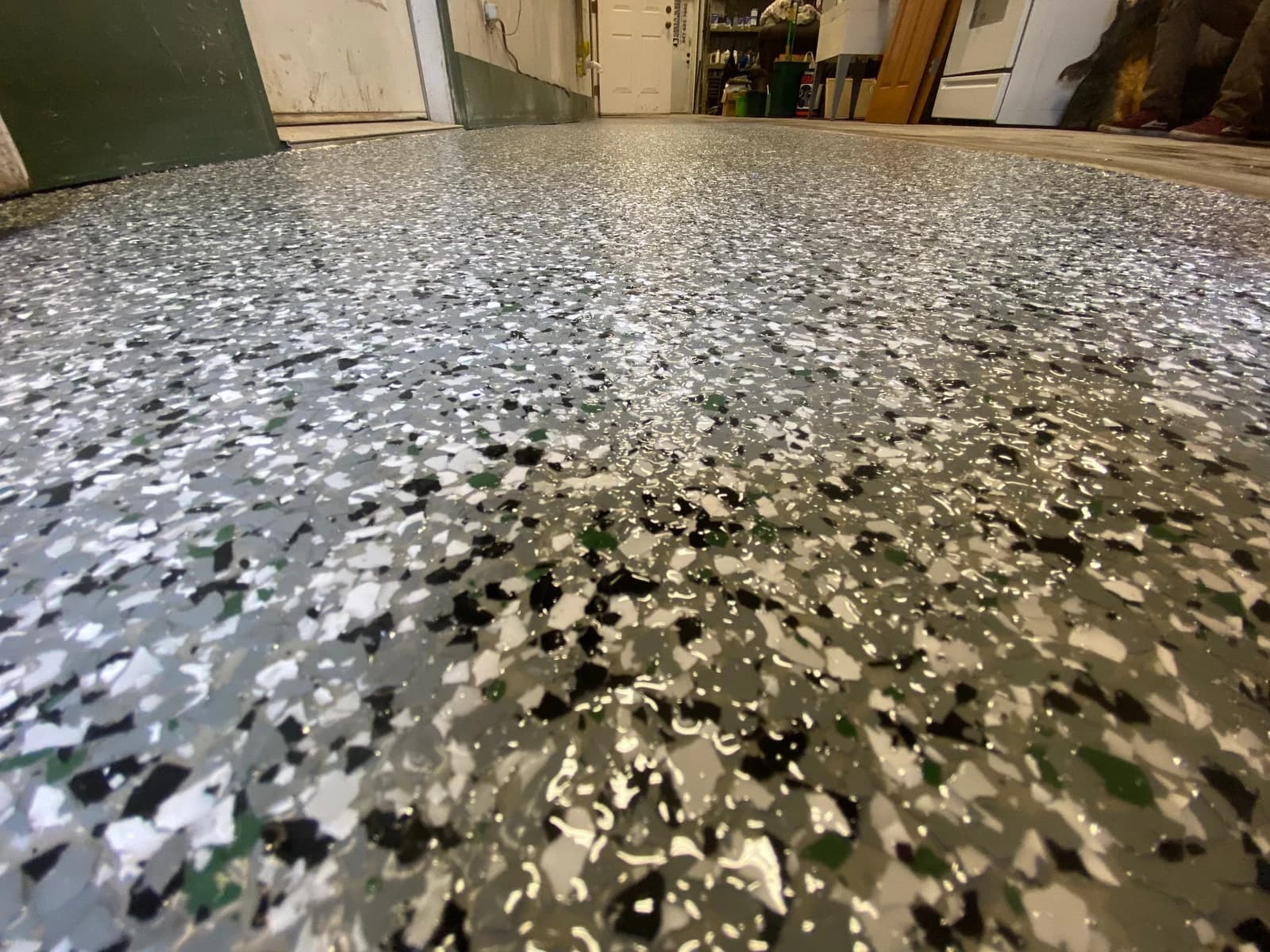 Close-up of a white and black flake floor coating with a glossy topcoat