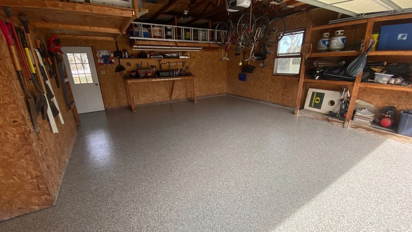 Home workshop with tool storage on a gray flake floor coating
