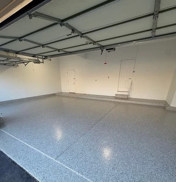 Residential garage finished with a gray flake concrete floor coating