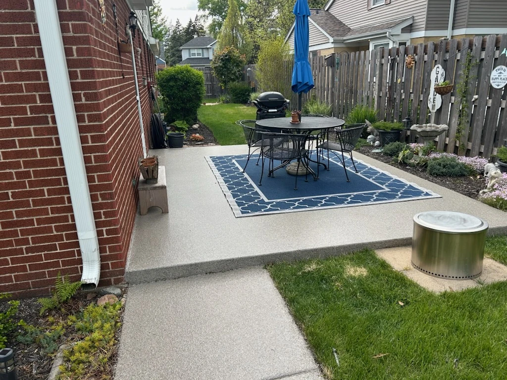 Backyard patio resurfaced with a textured flake concrete coating in Northern Illinois