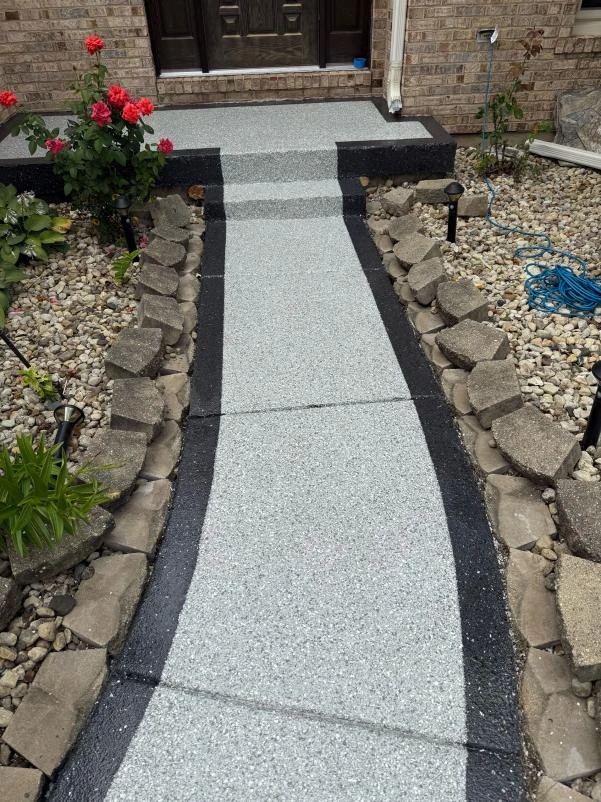 Two-tone walkway concrete coating with an Onyx border and Stargazer center leading to a front door