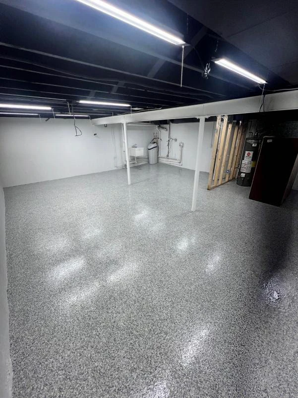 Unfinished basement utility area with a sealed gray flake floor coating